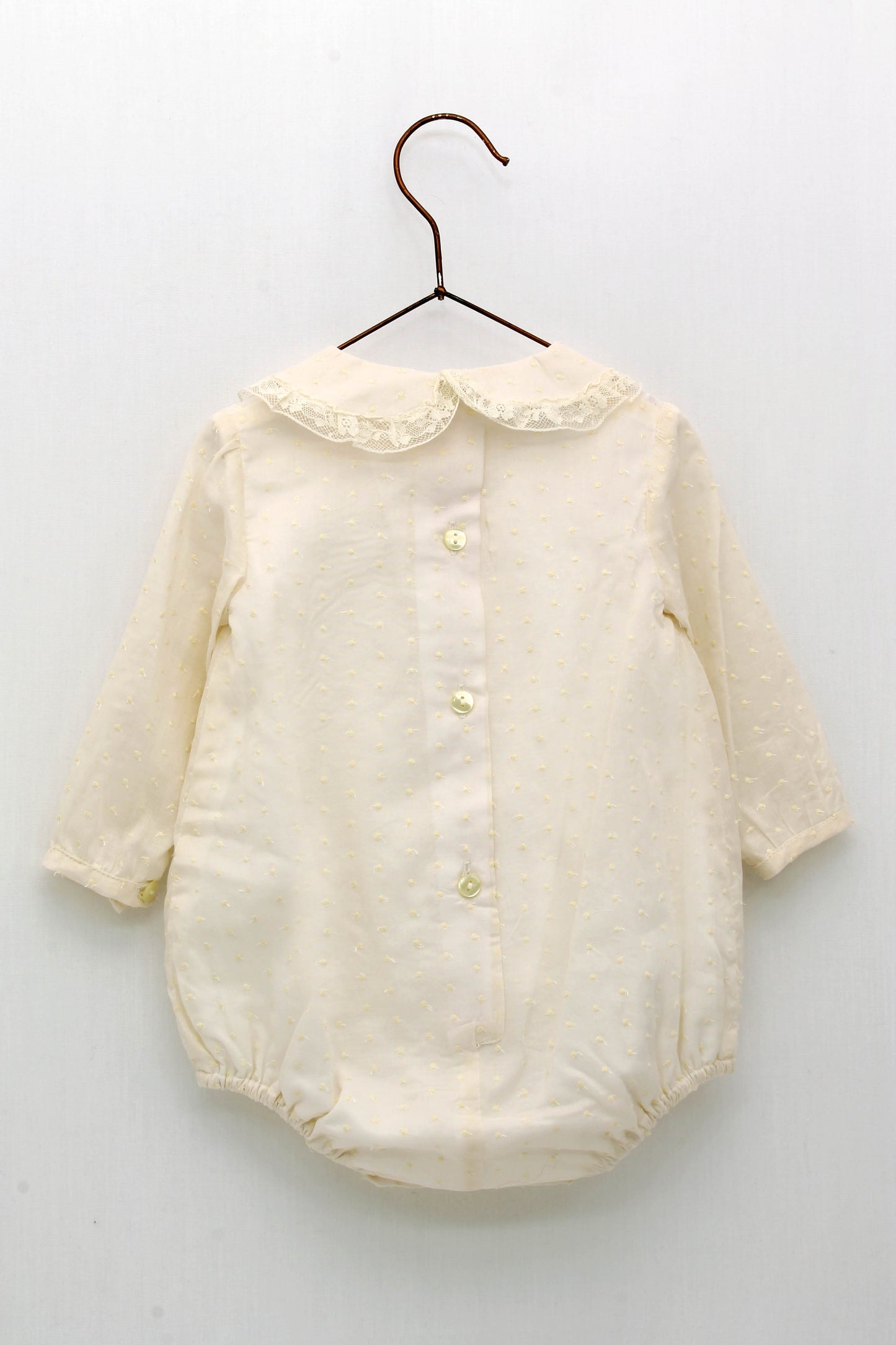 Baby romper with embroidered bodoque neck